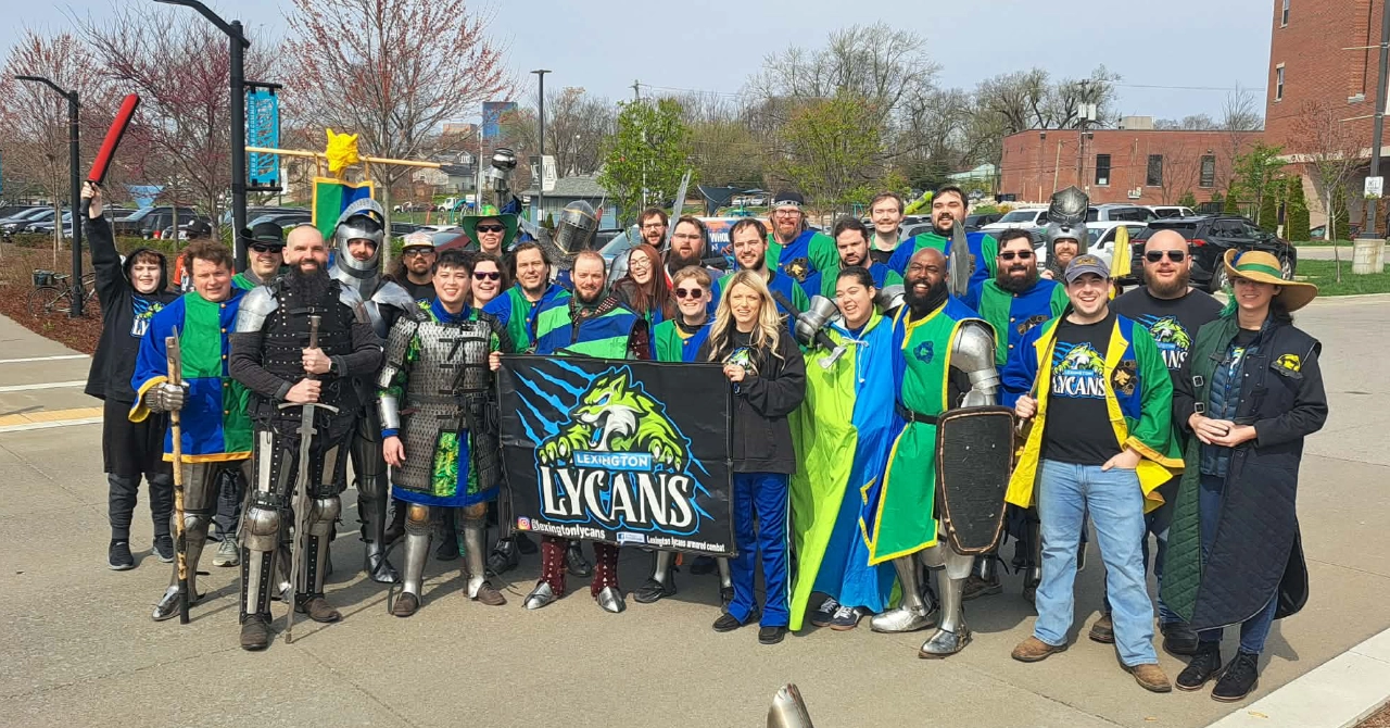 An image of the Lexington Lycans Armored Combat Team standing in team colors and full armor on a set of stairs.
