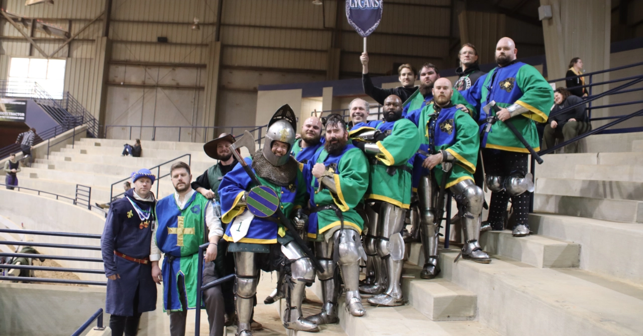 An image of the Lexington Lycans Armored Combat Team standing in team colors and full armor on a set of stairs.